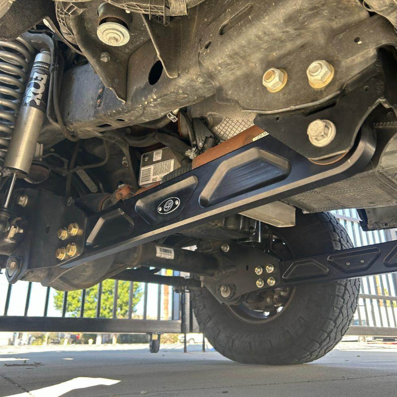 Undercarriage view of a vehicle showing the front suspension of an  SB Fully Loaded Kit For 2011-2016 F450  and steering system components.