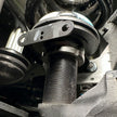 Close up Undercarriage view of a vehicle showing the front suspension of an  SB Fully Loaded Kit For 2011-2016 F450  and steering system components.