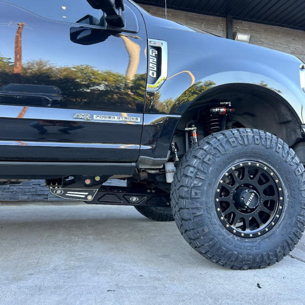Black pickup truck with an SB 3.5-5.5" Lift Kit For 2017-2022 F250/F350, showcasing the lifted wheel arch and the new tire.