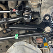 Close-up of a vehicle suspension system with metal components and bolts.