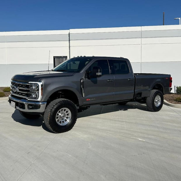 A black 2023+ F250/F350 pickup truck with an S&B 3.5-5.5" Lift Kit , parked against a white background.