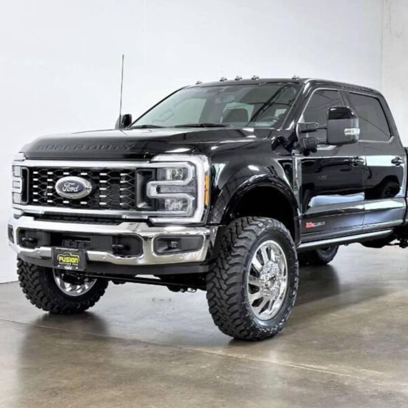 A black 2011-2022 F450 truck with an S&B 2.5 inch lift kit, including a front bumper, grille, and large tires for off-road use.