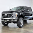 A black 2011-2022 F450 truck with an S&B 2.5 inch lift kit, including a front bumper, grille, and large tires for off-road use.