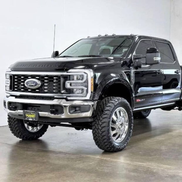 A black 2011-2022 F450 truck with an S&B 2.5 inch lift kit, including a front bumper, grille, and large tires for off-road use.