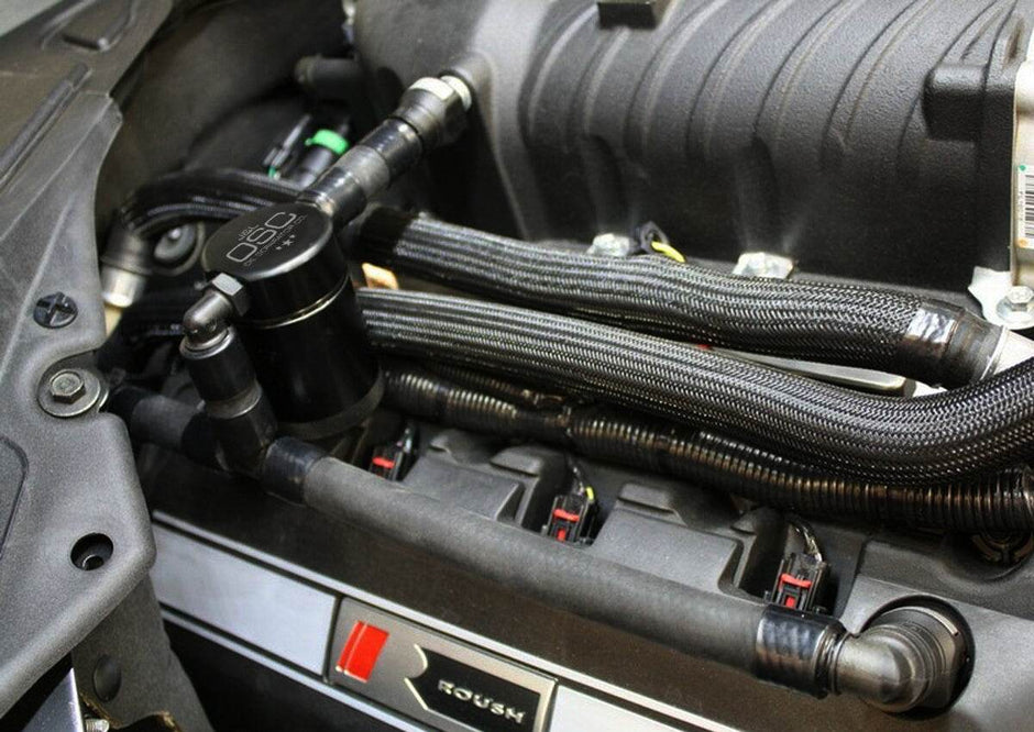 J&L Oil Separator 3.0 Passenger Side, Black Anodized installed in a car- S&B