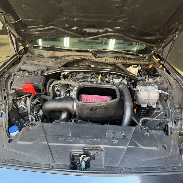 Car engine compartment with open hood, showing an SB Filters JLT Cold Air Intake For 2024-2025 Ford Mustang Ecoboost 2.3L Turbo