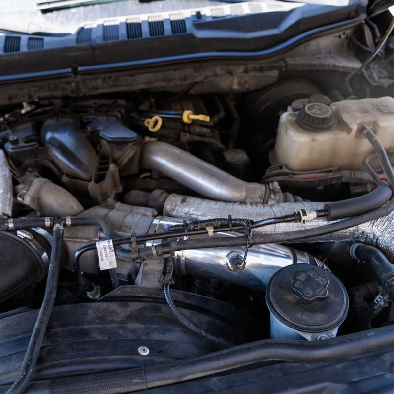 Close-up of an S&B Filters Cold Side Intercooler Pipe for 2023-2025 Ford Powerstroke F-450 / F-550 6.7L - installed in a car