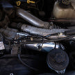 Close-up of an S&B Evaps Cold Side Intercooler Pipe for 2023-2025 Ford Powerstroke F-450 / F-550 6.7L installed in a car