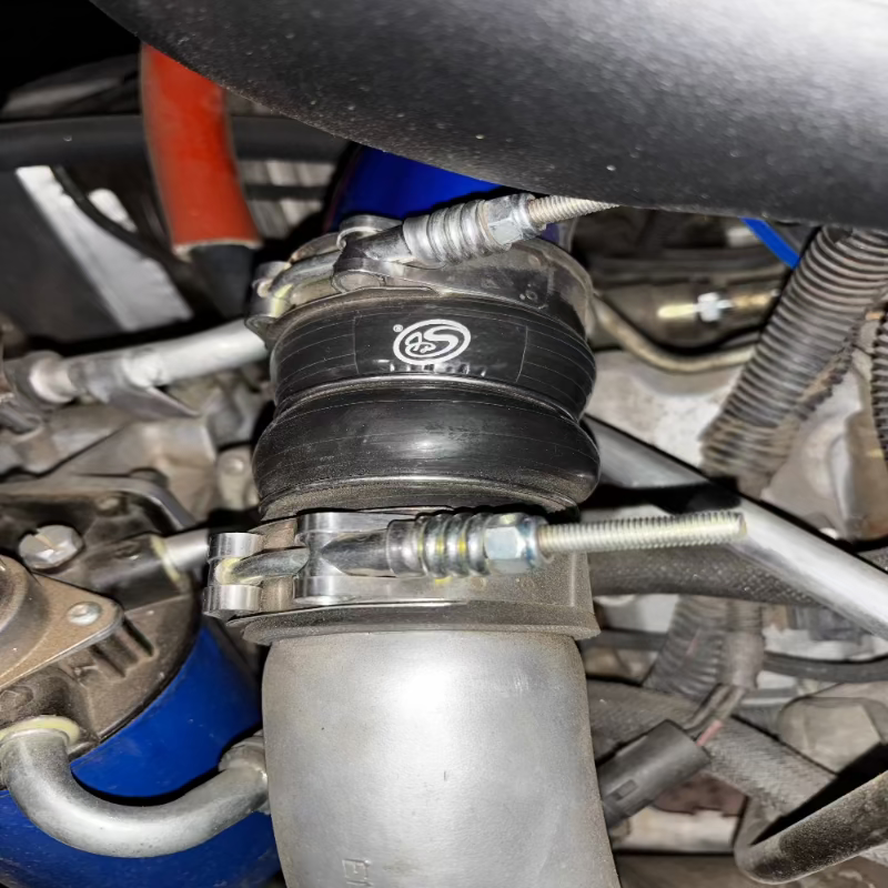 Close-up of an SB Filters Hot and Cold Side Boot Kit For 2004.5-2005 Chevy / GMC Duramax 6.6L (LLY)  on a vehicle's engine bay.