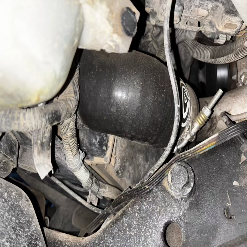 Close-up of an SB Filters Hot and Cold Side Boot Kit For 2004.5-2005 Chevy / GMC Duramax 6.6L (LLY) with visible components and oil leaks.