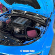 Blue car with open hood showing an SB Filters JLT Cold Air Intake for 2017-2024 Camaro ZL1 6.2L with a blurred background.