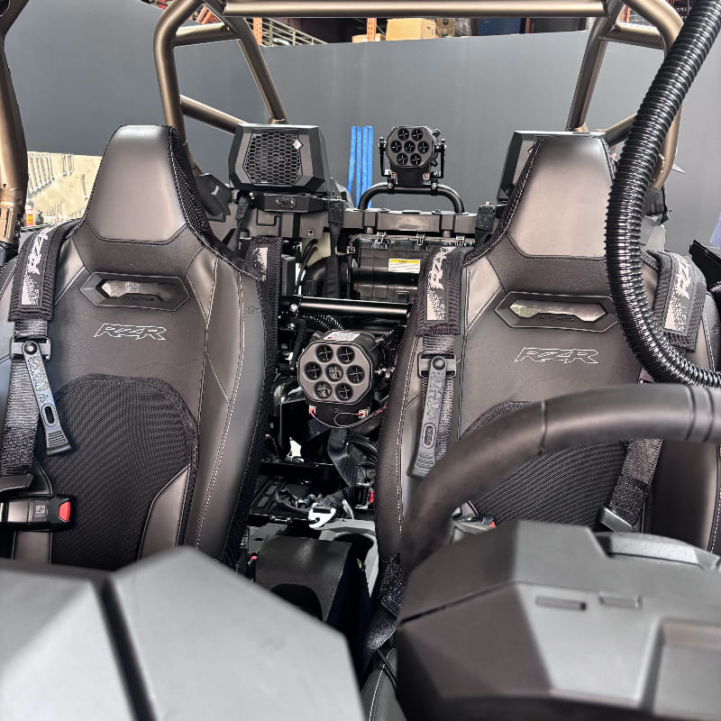 Close-up of the interior of a Polaris RZR vehicle with an SB Helmet Pumper with particle separator technology